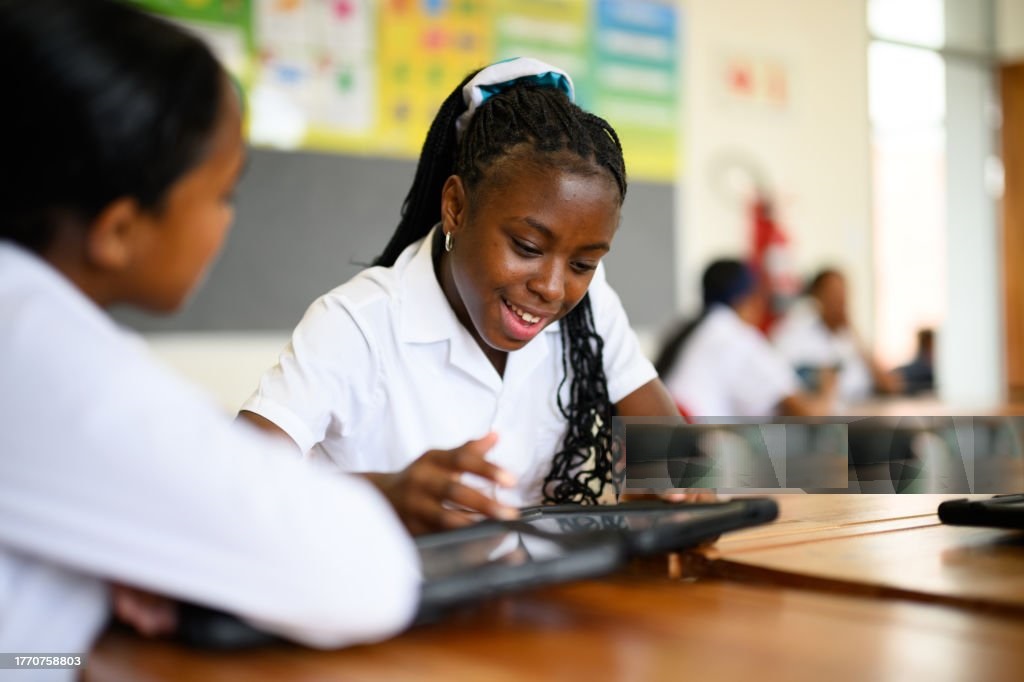 Multiracial schoolgirls using digital tablet in mathematics class